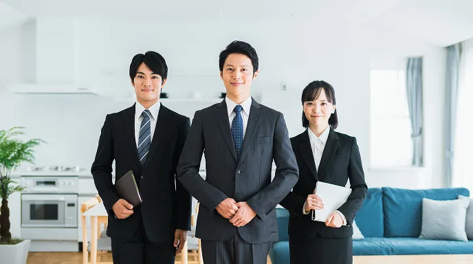 管理運営を担当する専門チームが室内で並び、契約後の賃貸管理をサポートする体制を表したイメージ。