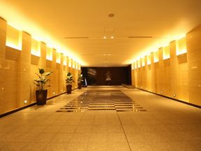 落ち着きのある雰囲気の壁や温もりのダウンライトが気品を湛えるイーストエントランス・ロビー(1階)